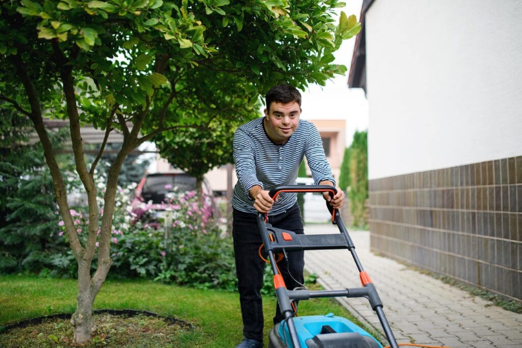 Young man mowing lawn