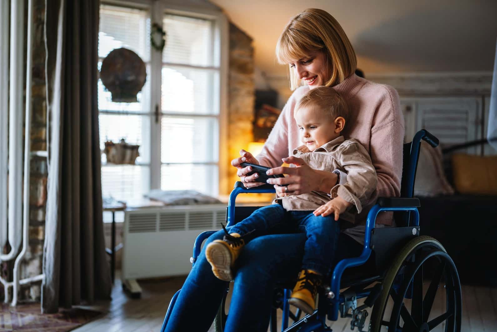 Mother in wheelchair using smart device
