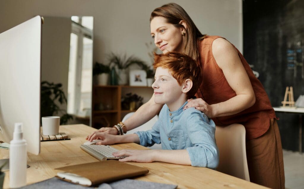 Mother and son using family computer